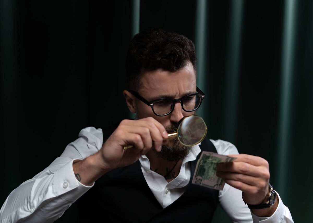 meticulous man using magnifying glass